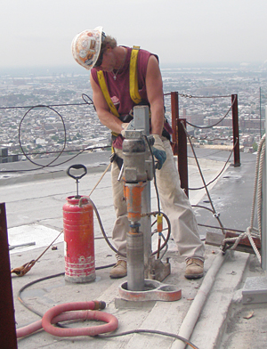 Coring operator atop building in Philadelphia